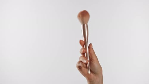 Professioneller Make-up-Pinsel zur Gesichtsanwendung in der Hand