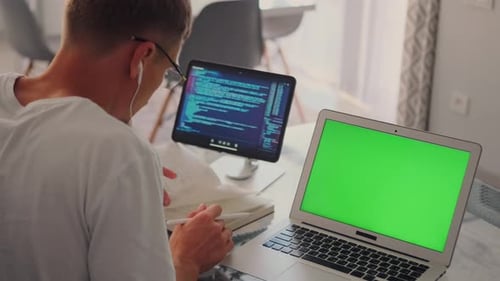 Developer Reviews App Design on a Video Call with a Tablet Displaying Code
