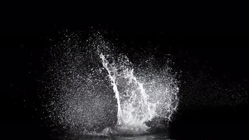 Abyss Collection: A large splash of water exploding very slowly from the center over a black backgro