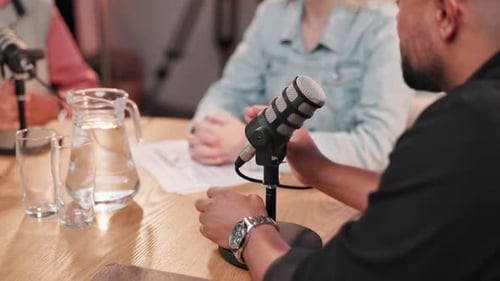Podcast, presenter and people with microphone for broadcast, conversation and talking for interview