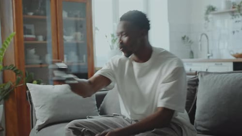Man Relaxing at Home Playing Video Game