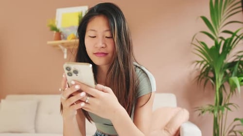 Young Woman Using Smartphone Indoors