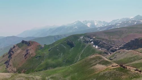 Breathtaking Aerial View of Snowy Mountain Peaks on a Clear Sunny Day
