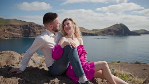 Romantic Couple Embracing and Enjoying Breathtaking Ocean View From Cliff