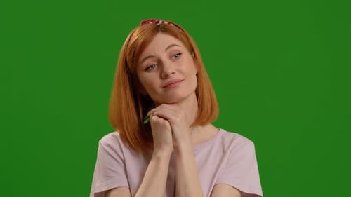 Portrait of thinking and wondering smart woman looks around isolated on green screen background stud