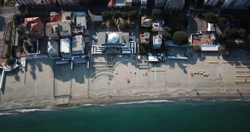 Top view of a sandy beach with the Mediterranean and a town, Genoa, Italy. Aerial drone shot