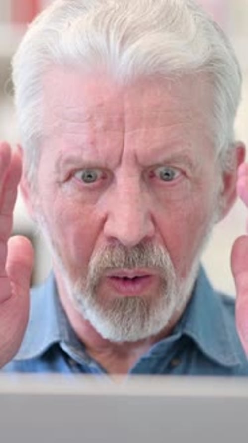 Close Up of Old Businessman Reacting to Loss on Laptop, vertical video