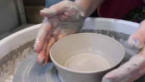 Hands Shaping Clay Bowl on Pottery Wheel