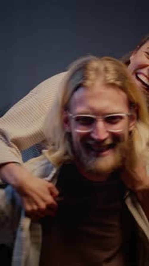 Affectionate Woman Riding Piggyback on Smiling Man