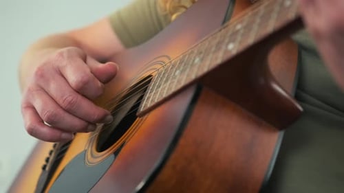 Close Up of Man Playing Acoustic Guitar