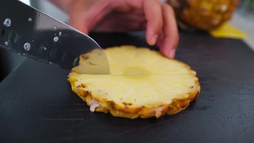 Knife Cuts Pineapple In A Bar For Preparing A Cocktail