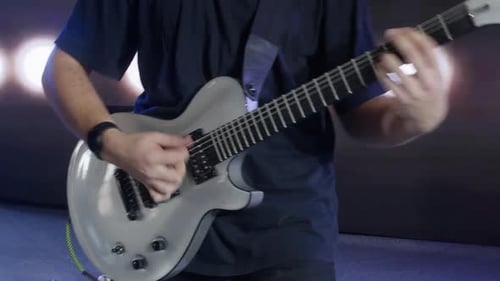 Musicians Playing Guitar on Stage at Concert