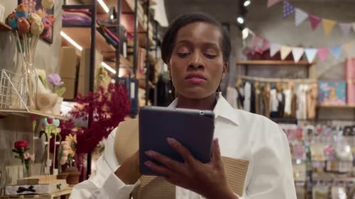 Female Store Worker Doing Stock Count Using Tablet