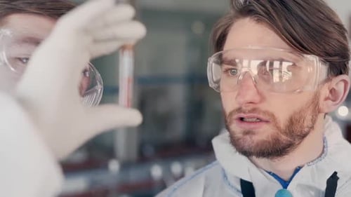 Scientists Examining Test Tube in Laboratory