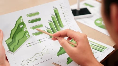 Businessman analyzing green power graph, energy from windmill. Delineation.