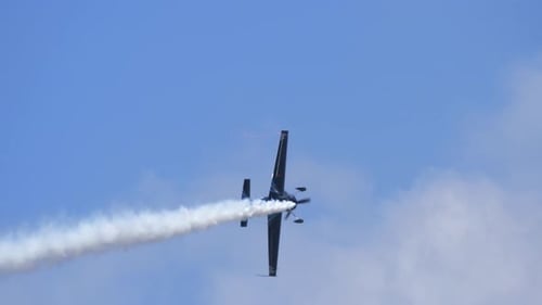 Stunt Plane Aerobatics Leaving Smoke Trail