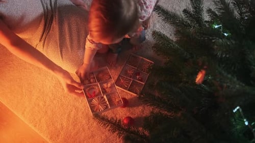 Woman and Child Decorating Christmas Tree at Home