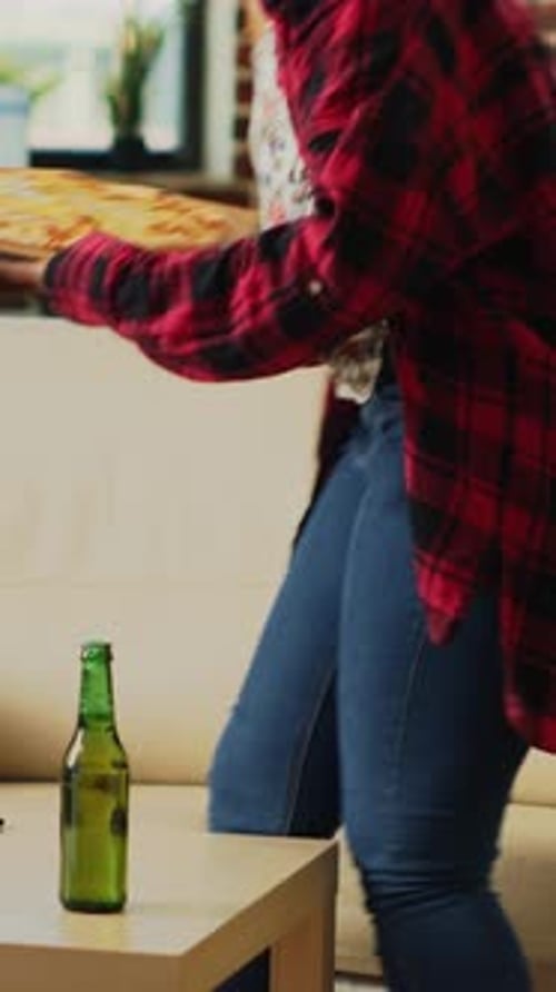 Vertical Video Smiling Girl Preparing to Eat Slice of Pizza at Tv