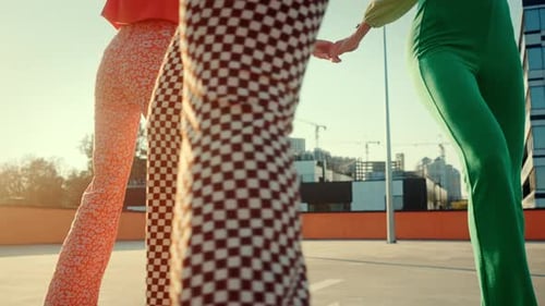 Close Up of Three Women Skating in Circle and Holding Hands