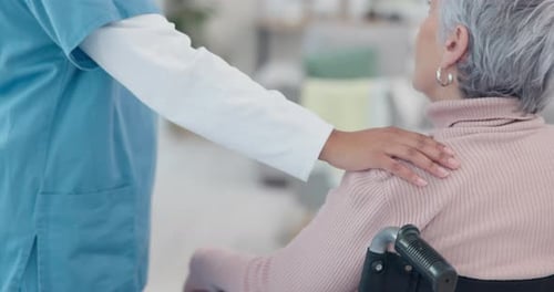 Supportive Medical Professional with Senior Woman in Wheelchair