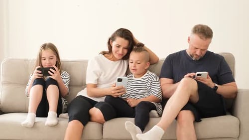 Family Relaxing Together While Using Mobile Phones