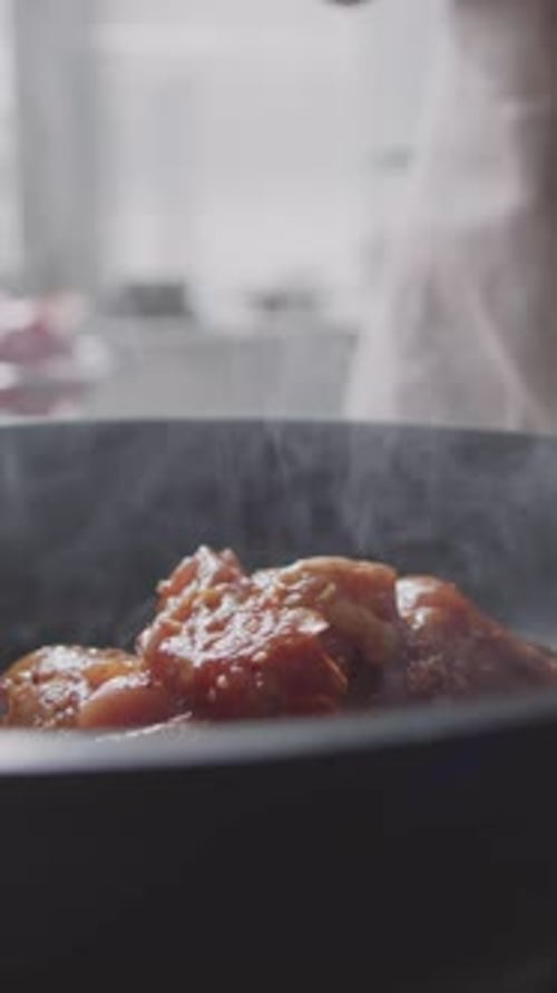 Close-up of Unrecognizable Chef Frying Chicken Breast on Sizzling Pan