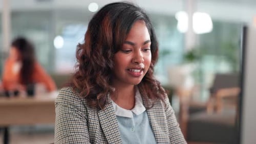 Woman, typing and computer in office with reading for review, editing or smile with article