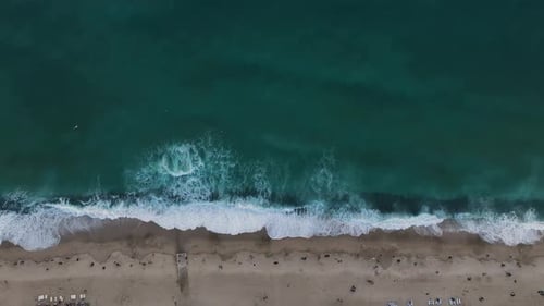 Top View of the Central Beach Drone Rotation Around Its Descent to the Beach