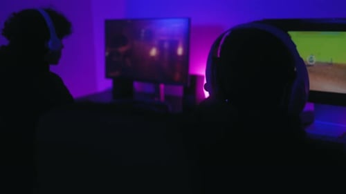 Two Gamers Playing Video Games at Night