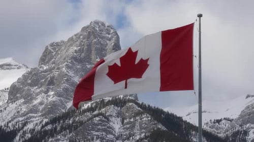 Canadian Flag Waving with Snowy Mountain Backdrop