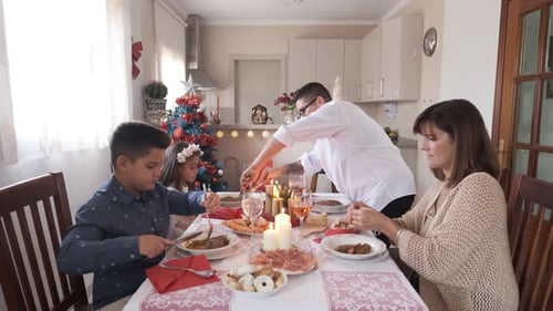 Family Celebrates Christmas Dinner at Home