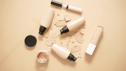 Beige Cosmetics Collection Overhead with Foundation Smears