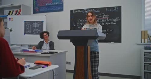 Teenage Girl Giving Presentation in Classroom Setting