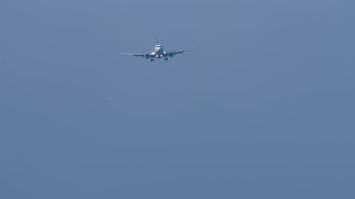 Passenger Airplane Approaching for Landing in Blue Sky