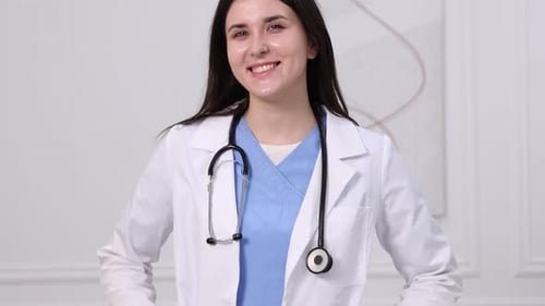 Smiling Woman Doctor in White Coat with Stethoscope