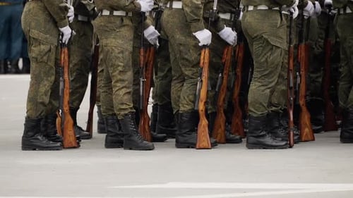 Close View of Uniformed Soldiers in Tight Formation with Woodenstock Rifles and Bayonets Grounded