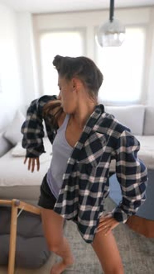 Woman Dancing Barefoot in Modern Apartment