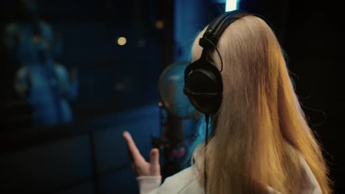 Blonde Woman Singing in Professional Recording Studio Voice Acting and Podcast Back View of Talented