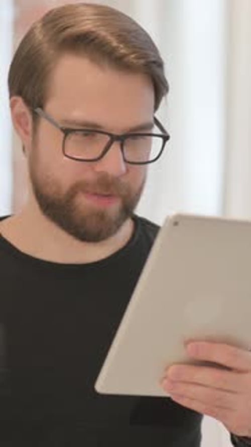 Bearded Man Using Tablet Indoors, Bad News, Sad