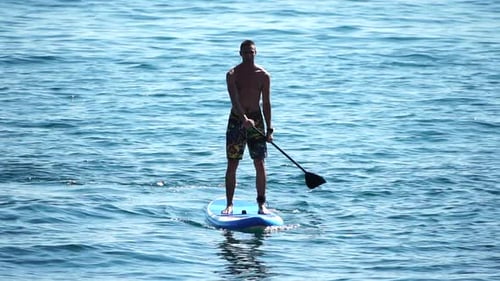 Man Sup Sea Strong Athletic Man Learns to Paddle Sup Standing on Board in Open Sea Ocean on Sunny