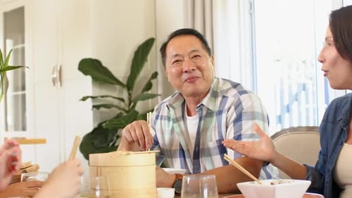 Family Celebrates Together at Home During Meal