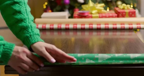 Woman Unwraps a Christmas Gift at Home