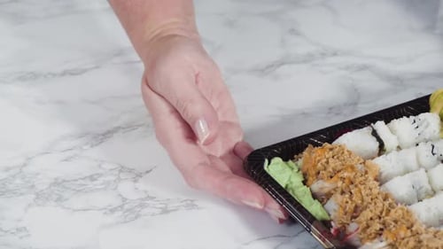 Prepackaged Variety of Sushi and Sushi Rolls in a Plastic Tray