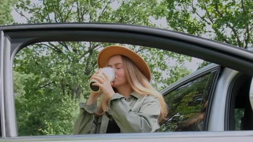 Smiling Young Woman Drinking Coffee or Tea From Reusable Thermos Cup Slow Motion Traveler Making a