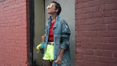 Stylish Woman with Roller Skates Posing Against Brick Wall