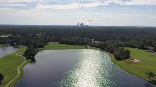 Aerial video of coal-burning power plant near environmental land