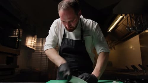 Chef Slices Food with Precision in Kitchen
