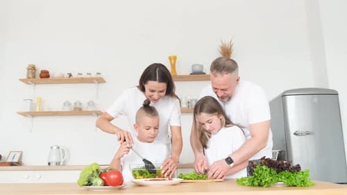 Young Happy Active Family Laughing Together Cooking at Home Cheerful Family