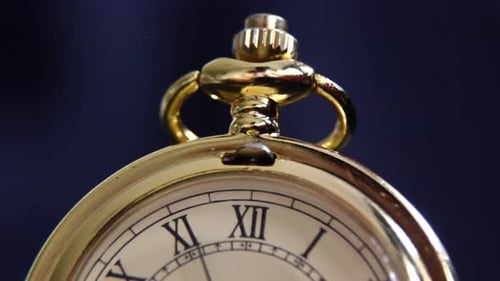 Gold Pocket Watch Close-up on Dark Background