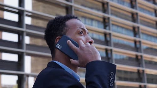 Professional Man Talking on Phone Outside Office Building